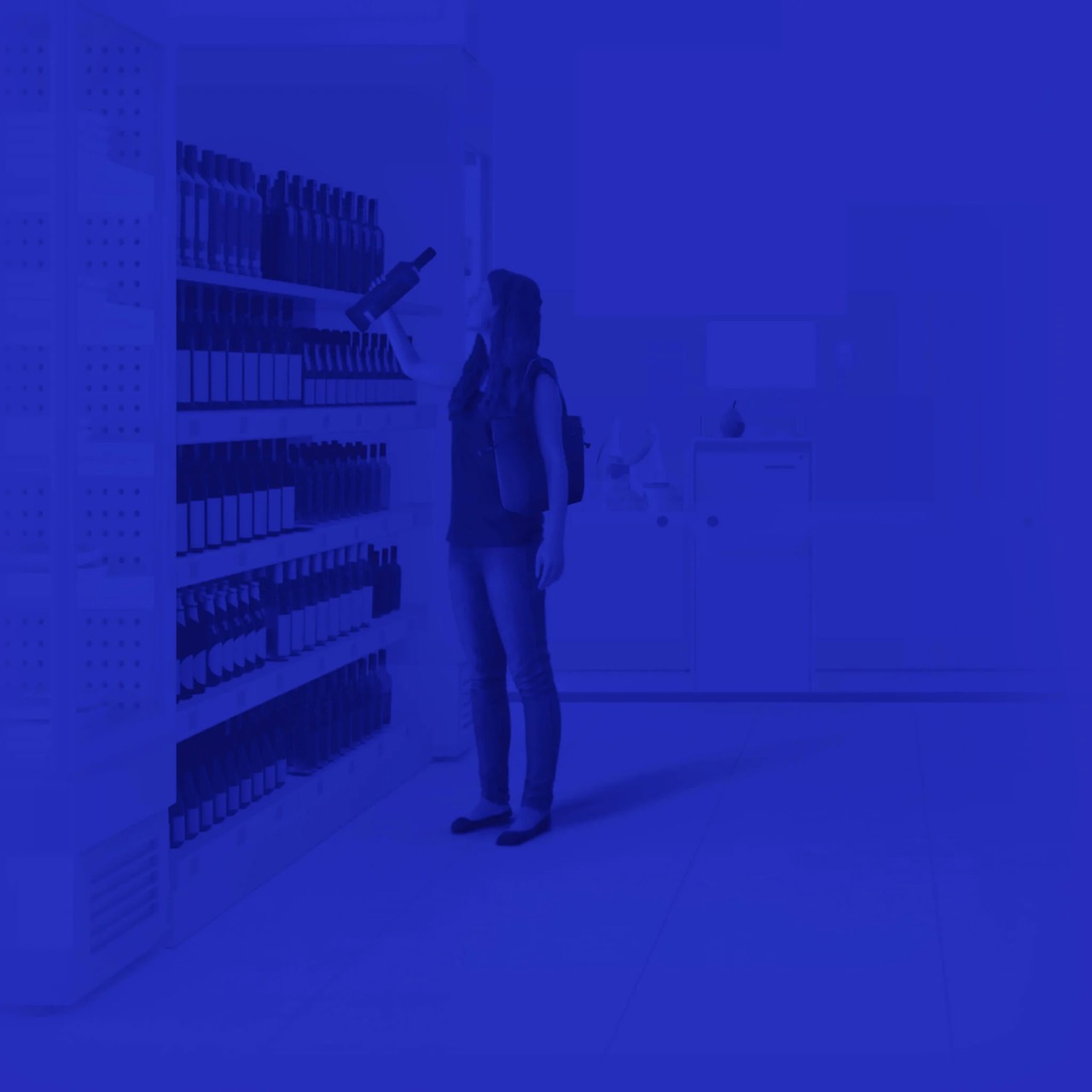 In-store camera view of a customer picking a bottle from a shelf, with AI detection overlays